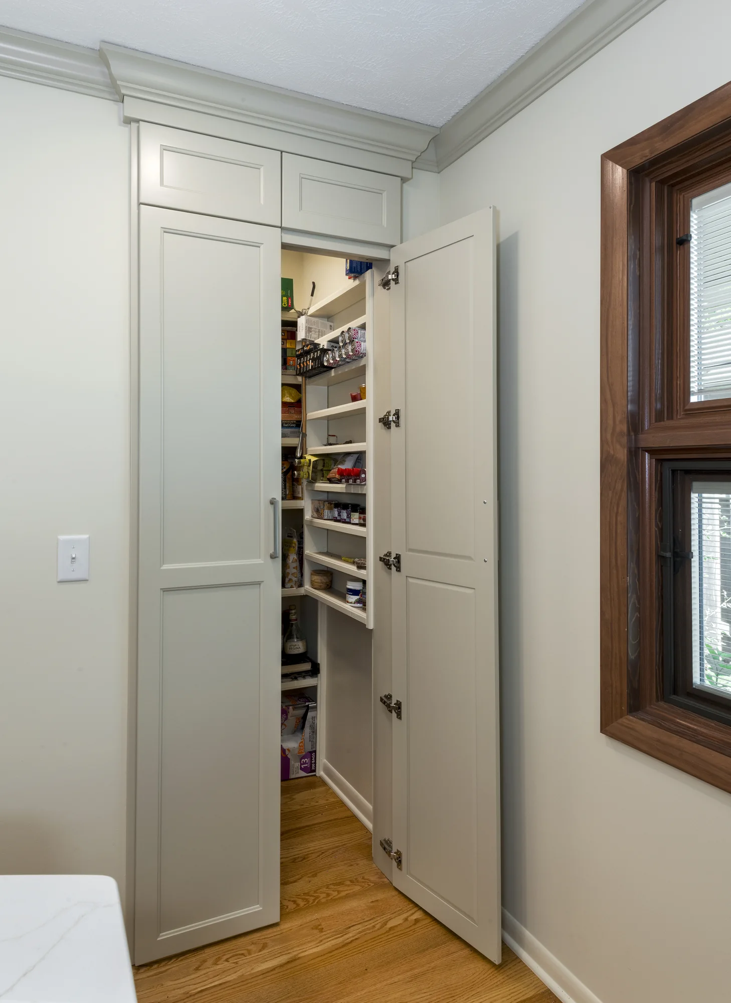 Concealed pantry storage beside the window