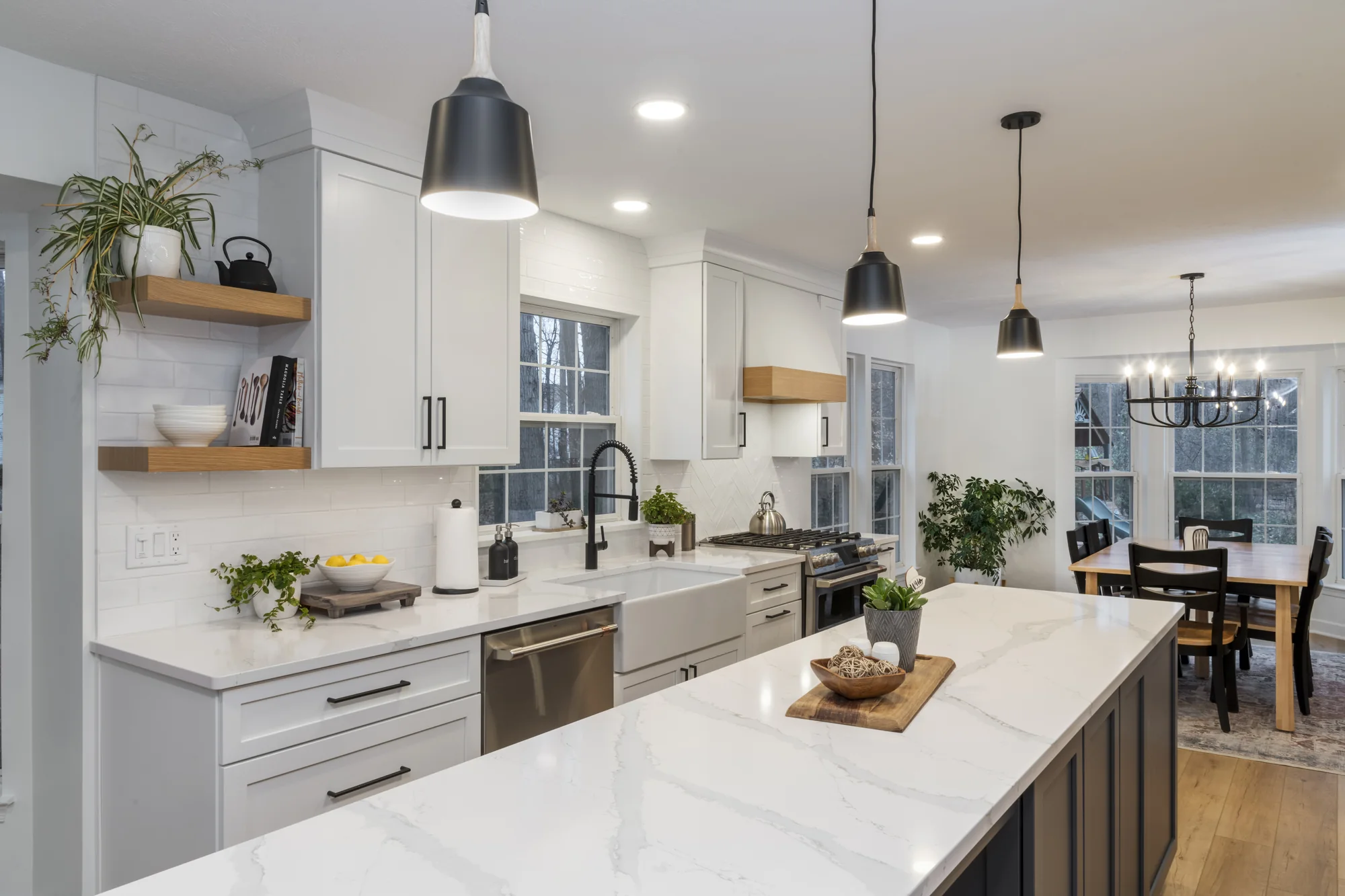 Wide view across the white kitchen and island