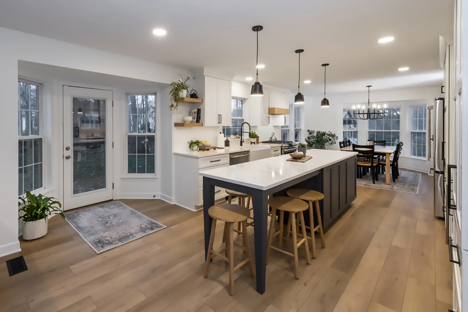 Contemporary white kitchen with a deep blue island in Olmsted Falls