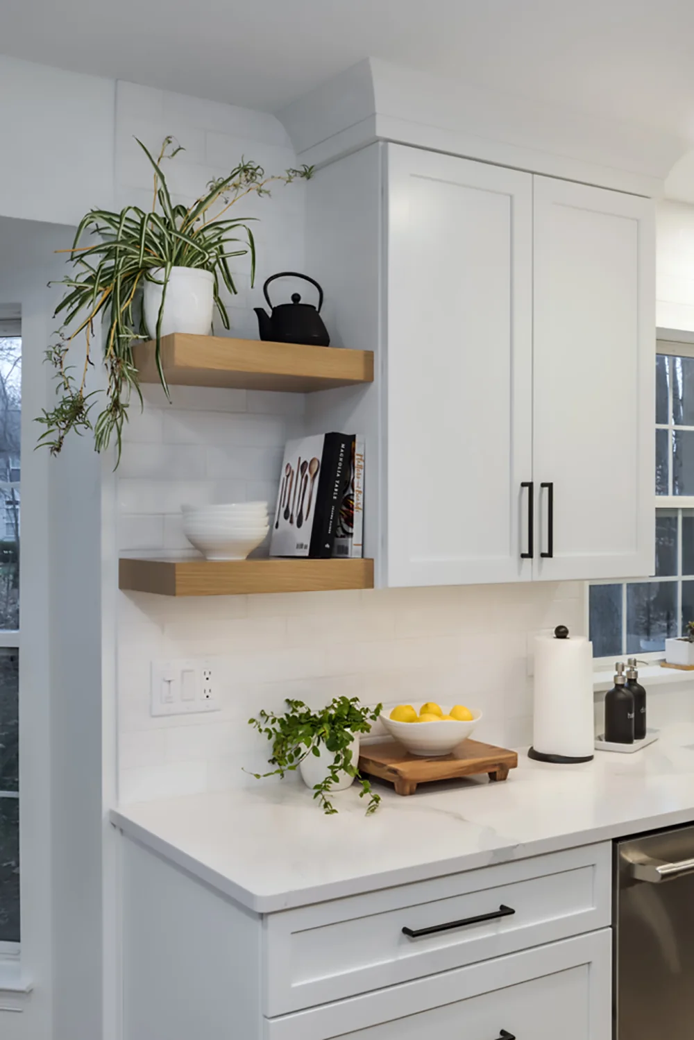 White cabinetry with natural wood floating shelves