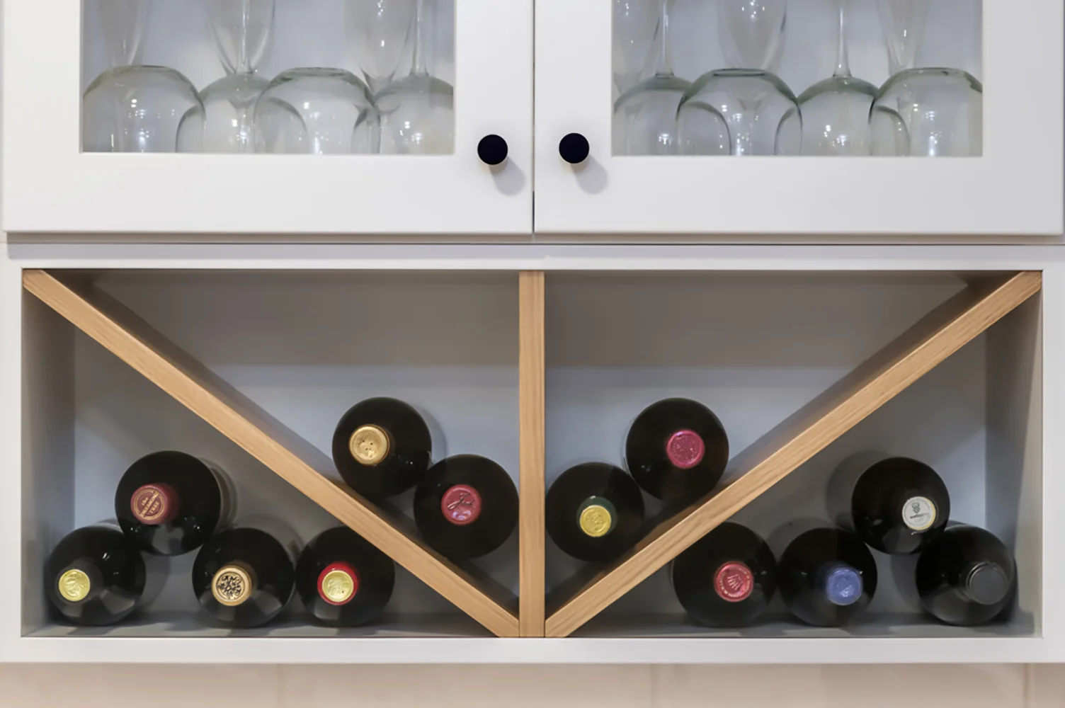 Custom wine storage built into white kitchen cabinetry