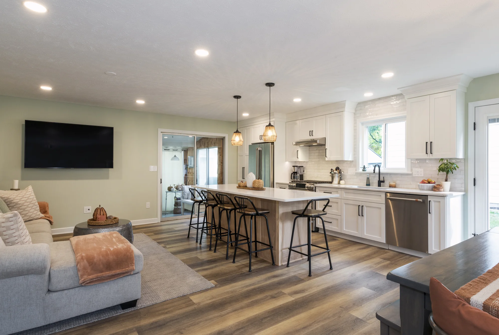 Open kitchen and living room centered around a natural wood island