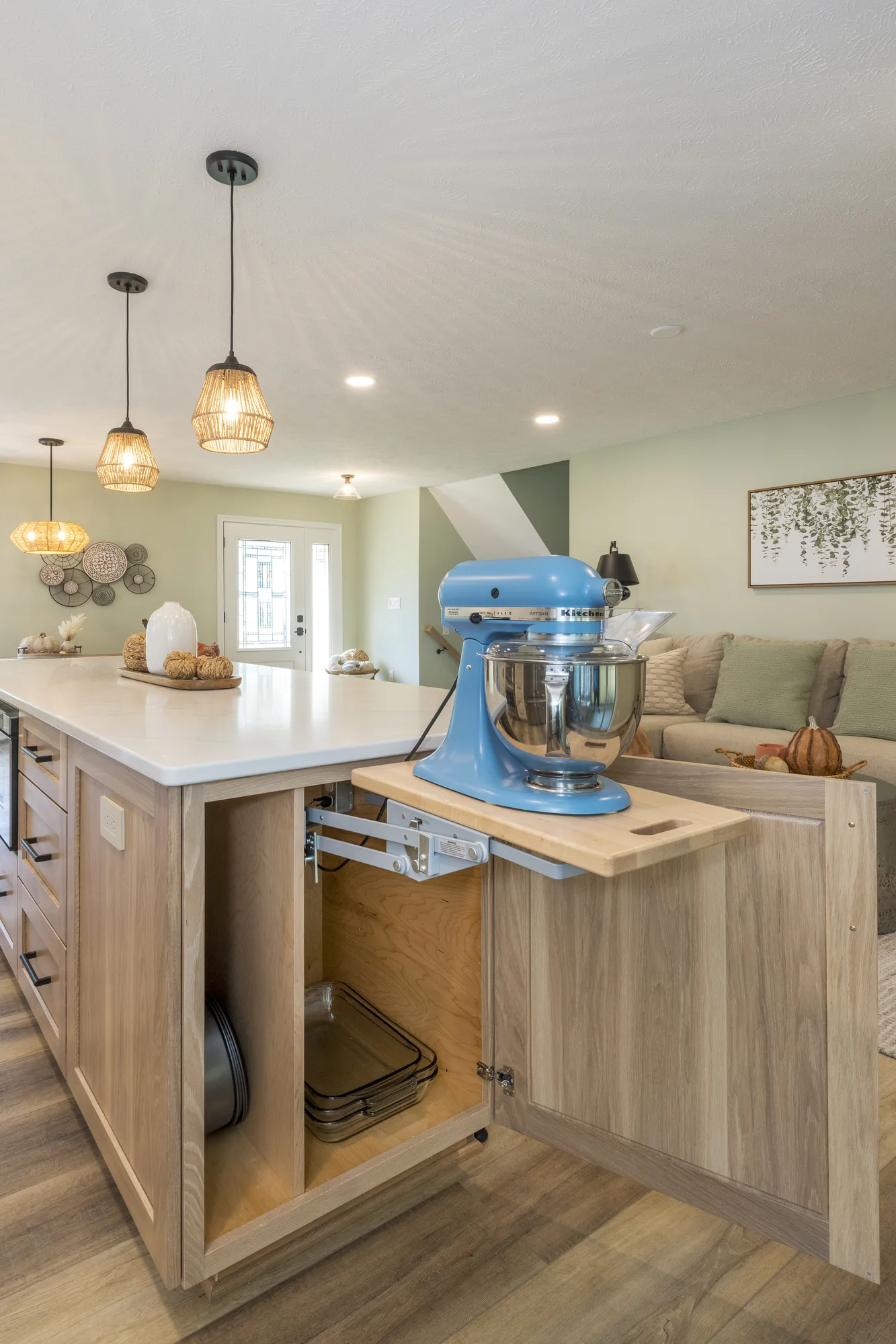 Built-in appliance lift inside the natural wood island