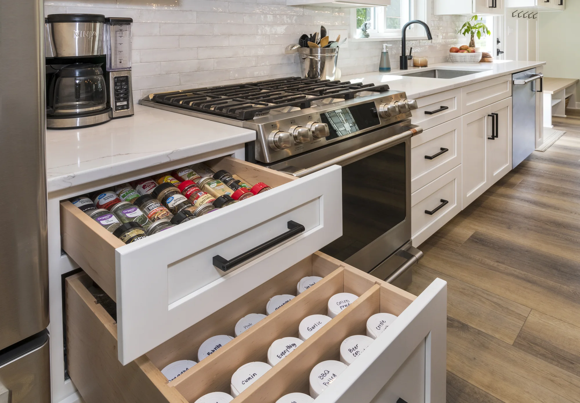 Organized spice drawer beside the range