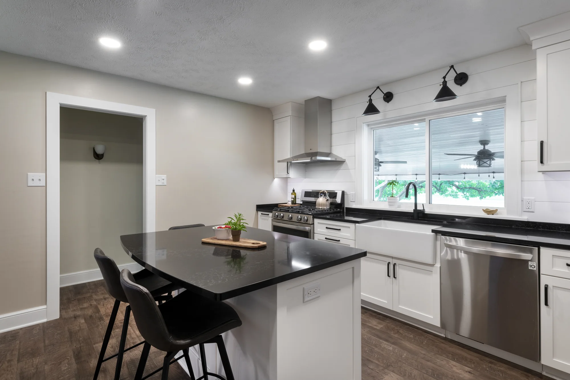 Kitchen island seating framed by white cabinetry