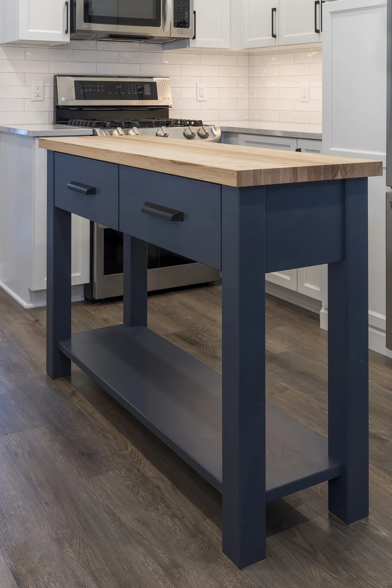 Dark blue worktable island with a natural wood top