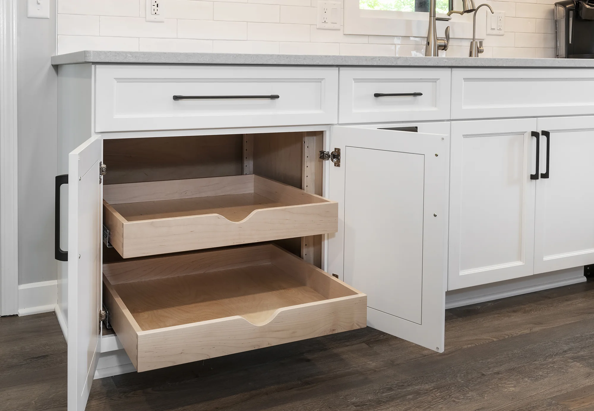 Open pull-out shelves beneath the white countertop
