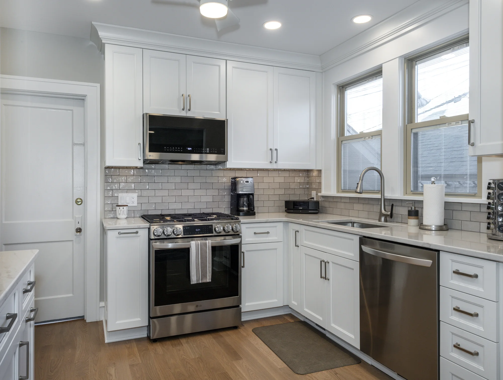 Traditional white kitchen viewed toward the range