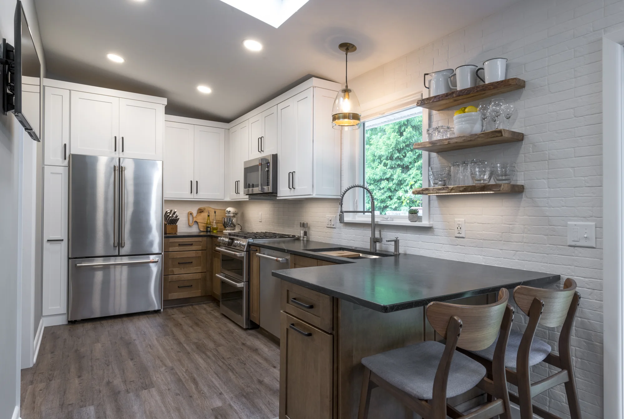 Two-tone kitchen with white upper cabinets and warm wood base cabinets in Olmsted Falls