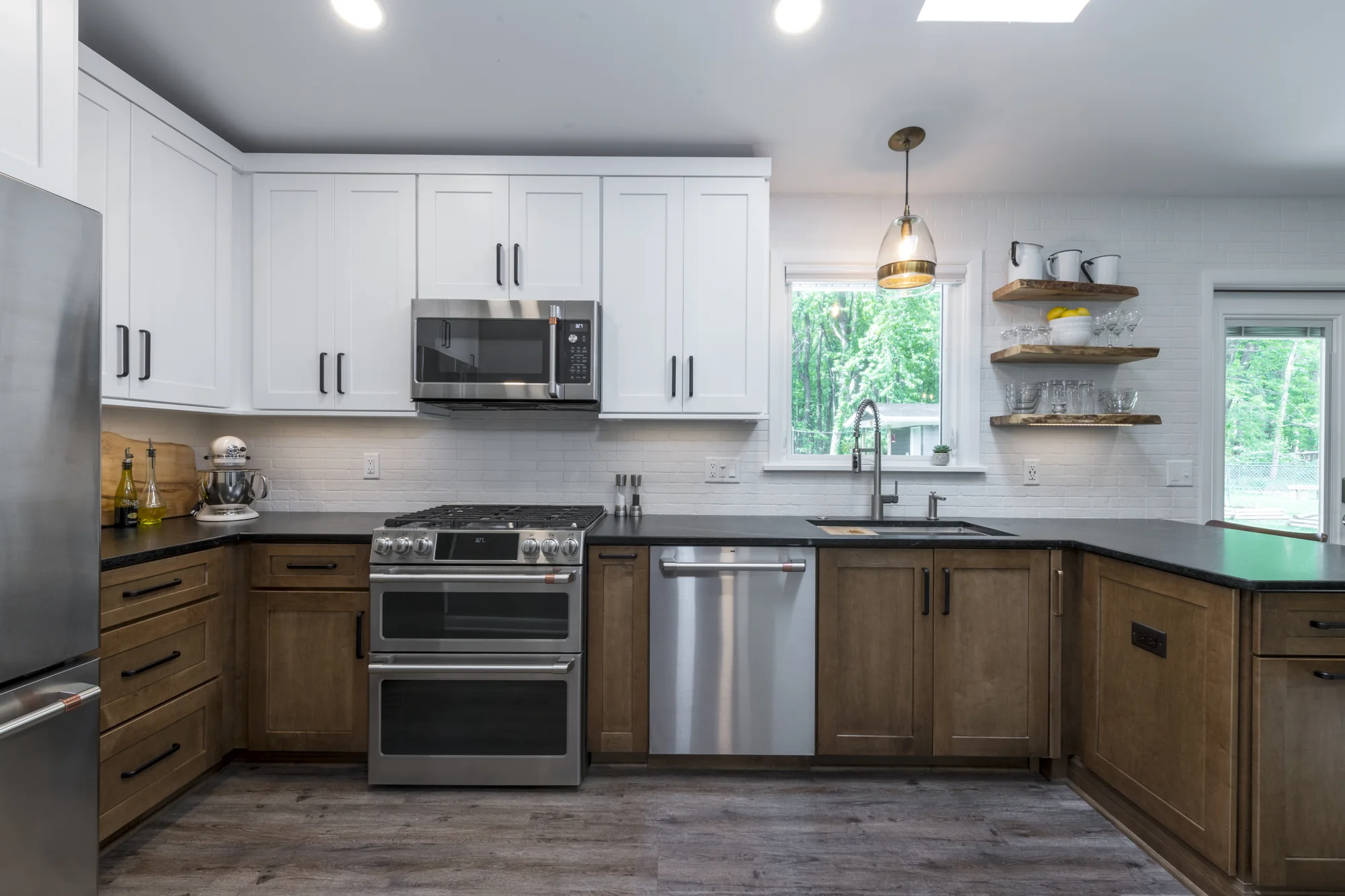 White and wood cabinetry surrounding the range and sink
