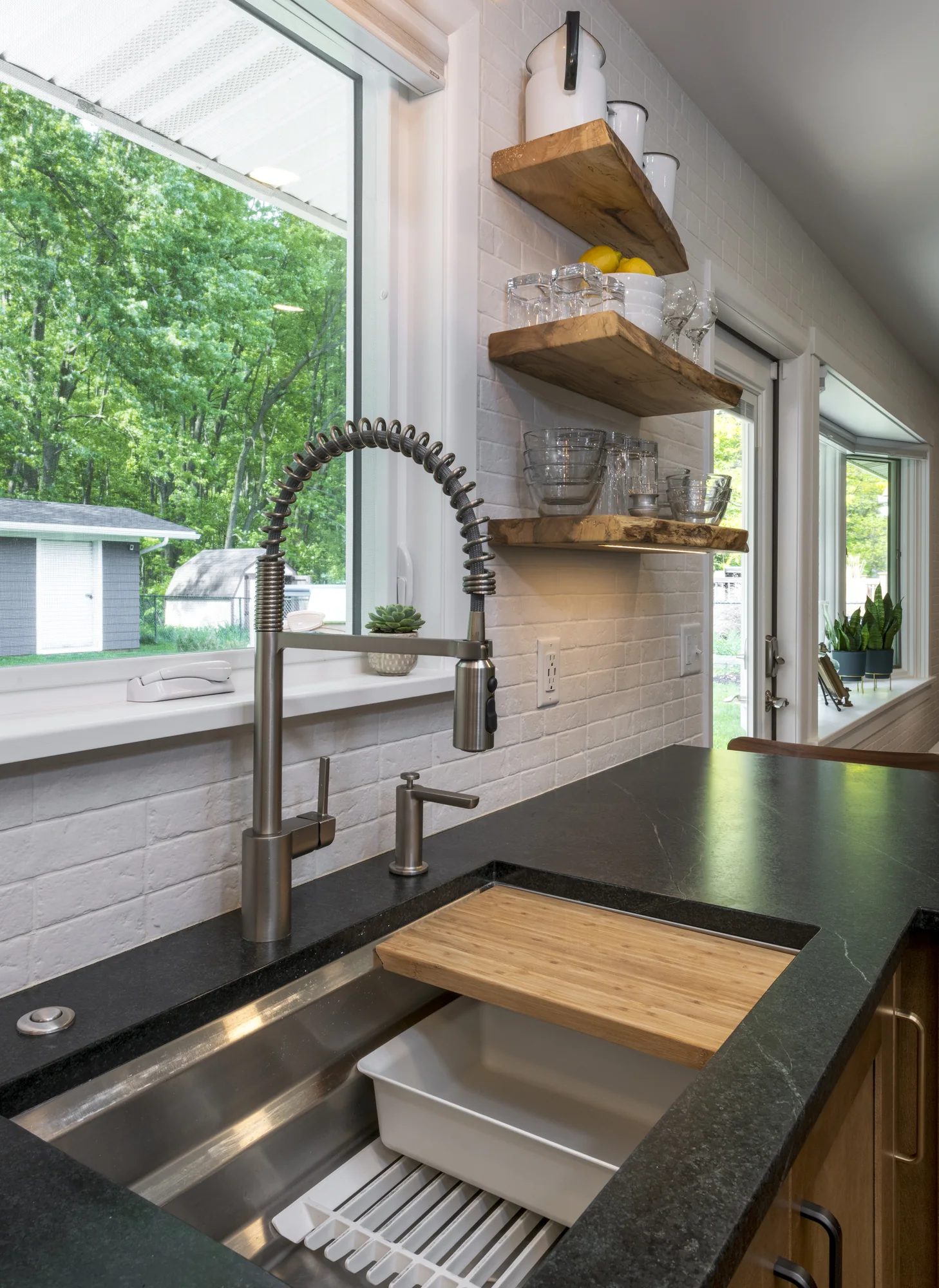 Workstation sink with integrated accessories and open shelving