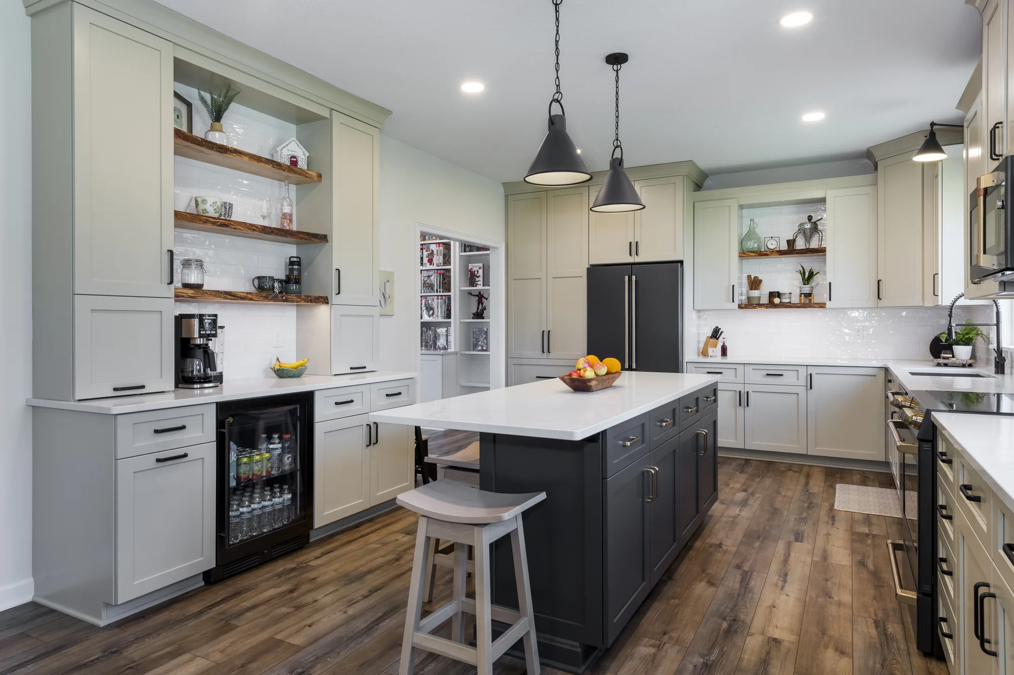 Dark island centered between the kitchen work zones