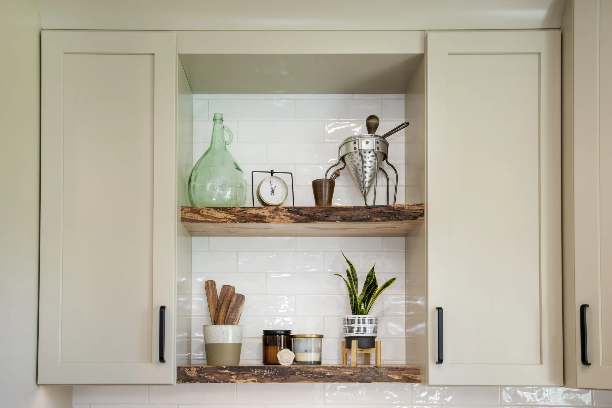Natural wood display shelves framed by warm cabinetry